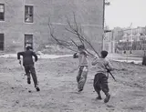 Helen Levitt, Boys playing with large branch, New York