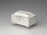 Jean Godet, A Berlin silver sugar box, Cuboid box resting on four feet; the offset hinged lid with a small beaded push-button. Original lock; key missing. H 9; W 13.3; D