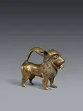 North German ca. 1200, A North German bronze aquamanile, around 1200, Cast, engraved, and chased bronze with remnants of gilding. This hollow, thin-walled vessel in the form of a lion was made using lost-wax casting technique and originally served in the liturgical washing of the priest's hands during Mass. The design of the aquamanile allows it to be grouped together with a series of eleven further lion aquamaniles which the research of Otto von Falke and Erich Meyer (op. cit.) has dated to the time around 1200 and assigned to a north German workshop, most likely in Lübeck. Today, the pieces are housed in various museums, the majority in the Germanisches Nationalmuseum in Nuremberg, the British Museum in London, the National Museum in Copenhagen and the Aachen Cathedral Treasury. X-ray fluorescence analysis carried out in 2021 has shown that this lion, which comes from private ownership, is made from an alloy of bronze, copper, tin and lead and shows no indication being created in the post-Medieval period. The amounts of the various metals used in the alloy also correspond to that of another lion aquamanile from the group of works compiled by Falke and Meyer now housed in the Germanisches Nationalmuseum (inv. no. KG 491, cf. Otto Werner: Analysen mittelalterlicher Bronzen und Messinge. Part IV, Berlin 1981, p. 186, analysis no. 238). Minor breakages to the back, with small rectangular repairs of the period. A large oval addition to the underside of the body, also of the period. The cap on the upper part of the head lacking, there presumably a small addition to the rim of the opening. Surface abrasions and minor dents