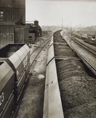 Kohlenzüge zur Kokerei Alma, Gelsenkirchen. Kokerei, Koksausstoss by Ruth Hallensleben, 1952. 1954, 2 vintage ferrotyped gelatin silver prints on Agfa-Portriga-Rapid paper, sold Dec 2023