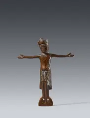 Limoges c. 1200, A Limoges enamelled bronze Corpus Christi, around 1200, Cast and engraved bronze with old patina and minimal remains of enamel. Depicting the crowned figure of Christ crucified with four nails, with His arms horizontally outstretched. Minimal dents with losses to the crown
