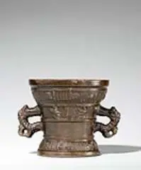 Werkstatt Hachmann, A Hachmann mortar made for Johan Linit, Golden brown cast bronze with rich chocolate brown patina. The display side decorated with a vacant coat-of-arms supported by winged demi-figures. With two wide banderoles below the rim and above the base inscribed in Gothic minuscule: “johan linit ? so got furh my ghenuch” and “int iaer ons heren m vc lxviii”. The handles formed as double-headed dragons. H 12.8, D