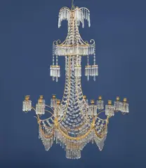 Werner & Mieth, An opulent chandelier in the form of a Chinese pagoda, Gilt bronze/brass, cut glass. With twelve branches issuing from six arcs forming the lower hoop. Six further lanterns issuing from the crystal canopy above, surmounted by six palm branches hung with crystals. The tapering shaft densely draped with crystal adorned horizontal chains. H c. 130, D c