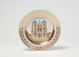 A Berlin KPM porcelain plate by Königliche Porzellanmanufaktur Berlin Kpm, "Antikglatt" model, decorated with a view of Regensburg Cathedral after an engraving by Carl Schleich based on a drawing, sold May 2022