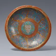 Limoges first half 13th century, An enamelled bronze dish with the French coat-of-arms, Rolled, embossed bronze with engraved, gilded and enamelled decoration. A finely worked dish displaying a balanced composition using the contrast of the polychrome enamels against the gilding to provide an impressive overall impression. The border picked out in red with an angular gold frieze. The lip decorated with a frieze of six women in courtly attire shown in dancing poses against blue enamel ground encompassed by turquoise arches and delicate gold tendrils. The centre of the bowl decorated in the same colours and reiterating the designs of the rest but with a central quatrefoil motif surrounding a heraldic shield. The coat-of-arms with gold lilies on pale blue ground is that used by the French royal family under Philippe Auguste II (1179-1223), Louis VIII “The Lion” (1223-1226) and Louis IX “The Saint” (1226-1270). In good overall condition. The lip with two small drilled holes. With dents, abrasions, and minor losses to the enamel