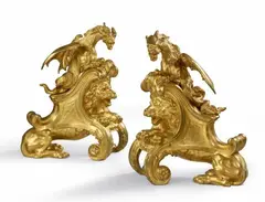 Charles Cressent, A pair of ormolu fire dogs with lions and dragons, Finely chased bronze models cast with integral slanted plinths. The backs hollow. H 37, W 31.5 and H 36.5, W