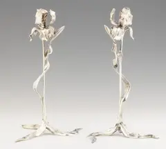 Léopold van Strydonck, A pair of silver-plated bronze lily lights, Silver plated bronze. Cast in one chased, engraved and polished. Designed as iris flowers, the four-sided candle prickets in the centre of the blooms and the three curved leaves forming the feet. H