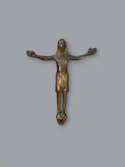 Maasland, A bronze Corpus Christi, presumably Maasland, first half 13th century, Engraved cast bronze with minimal remains of former gilding. A depiction of Christ with His head upright, His arms spread horizontally to the sides, His legs parallel and His feet resting on a subpedaneum. The figure's nudity is concealed by a perizonium knotted in the centre. Abrasions. Mounted on a velvet covered panel