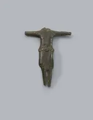 Maasland, A bronze Corpus Christi, presumably Maasland, first half 13th century, The reverse hollowed out, engraved bronze with older patina. Depiction of Christ crucified with three nails and His arms stretched out horizontally. Despite the fragmentary condition of the piece, its fine quality is still evident to this day, especially in the detailed rendering of the perizonium and the engraving. Head, hands, and feet missing. Abrasions throughout