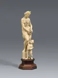 attributed to Adam Lenckhardt, A carved ivory Venus and Cupid group attributed to Adam Lenckhardt, Carved in the round and partially freestanding. A figure of Venus shown standing and dressed only in a perizonium, placing her extended right foot upon a boulder. At her feet, the little Cupid is depicted handing her an apple. This small and finely carved sculpture is traditionally attributed to Adam Lenckhardt, one of the most important representatives of Baroque ivory carving. Following an apprenticeship under his father Nikolaus Lenckhardt, Adam Lenckhardt travelled throughout Italy before settling in Vienna in 1638, where he advanced to become the chamber sculptor of Prince Karl Eusebius of Liechtenstein from 1642 to 1660. The wing, formerly attached with a dowel, lost as well as the bow that Cupid would have originally held in his left hand. Some discolouration. Mounted on a modern wooden plinth