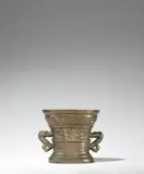 Werkstatt Hachmann, An early Hachmann mortar made for Berndt Opterstraet and Margriet Markolfs, Golden brown cast bronze with honey coloured natural patina. Decorated on the display side with a vacant coat-of-arms supported by two winged demi-figures. With two broad overlapping banderoles below the rim inscribed in Latin capital letters: “BERNDT OPTERSTRAET MARGRIET MARKOLFS” and “SIN HVISFROVW ANNO XVC L”. With two zoomorphic handles. A horizontal crack along the front, some small cracks around the base of the right handle, minor abrasions. H 12, D
