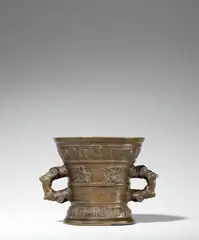 A dated Hachmann mortar by Werkstatt Hachmann, Golden brown cast bronze with honey coloured patina. The display side decorated with a vacant coat-of-arms supported by , sold Jun 2021