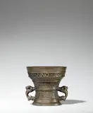 Hendrick Wegewart, jr., A dated Dutch mortar with a romantic inscription, Golden brown cast bronze with honey coloured natural patina. With a central horizontal moulding, two bands of acanthus, and half-length grotesque figures flanked by cornucopias and arabesque tendrils. With a broad inscription in capital letters below the rim: “AMOR VINCIT OMNIA ANNO 1606”. With zoomorphic handles. H 13.5, D