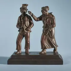 Simeon Pierre Devaranne, Two cast iron figures of typical Berlin caricatures, Cast iron with copper/bronze coloured patina. Depicting “Eckensteher Nante” and “keifendes Weib” on an oblong plinth. H