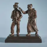 Simeon Pierre Devaranne, Two cast iron figures of typical Berlin caricatures, Cast iron with copper/bronze coloured patina. Depicting “Eckensteher Nante” and “keifendes Weib” on an oblong plinth. H