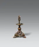 Hildesheim second half 12th century, A Hildesheim bronze dragon candelstick, second half 12th century, Cast bronze with old patina. The base of this tripod candlestick is decorated with stylised dragons beneath a round pommel and a wide, protruding drip pan. The piece displays strong stilistic similarity to a dragon candlestick in the Diözesanmuseum in Münster, which Otto von Falke (op. cit.) published as a Westphalian work dating to around 1200. Very minor wear and dents. The iron pricket presumably an older replacement