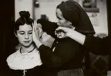 Inge Morath, Navalcan, Old Castille, Bridesmaid being coiffed by sister and grandmother