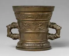 A Hachmann mortar made for Philip Pheuenruten, A Hachmann mortar made for Philip Pheuenruten, Yellowish gold cast bronze with natural patina. The display side decorated with two demi-figures supporting a vacant shield, the reverse with a depiction of the veil of Veronica in a round medallion flanked by two putti. Two broad bands around the rim and the domed base inscribed in Gothic minuscule: "philiyps pheuenruten syn hiusfrouw" and "int jaer ons heren m vc lxxIII". Slight greenish corrosion to the interior. H 14.5, D