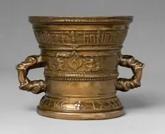 A Hachmann mortar made for Sibert and Elysabet Botliembecher, A Hachmann mortar made for Sibert and Elysabet Botliembecher, Golden brown cast bronze with shimmering natural patina, partially engraved. Both sides decorated with shields held by two demi-figures and two putti. The rim and the centre with cymatium mouldings. With two broad bands below the rim and around the base inscribed in Gothic minuscule and Latin majuscule: “sibert botliembecher elysabet syn huisfrouw” and “ANNO DOMINI M VC LXXVIII”. H 15.7, D