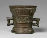 A Hachmann mortar made for Lisbet van Till by A Hachmann mortar made for Lisbet van Till, Cast bronze with dark brown patina. The display side decorated with winged demi-figures supporting a shield with a house, sold May 2020