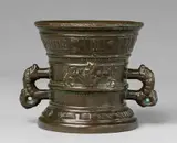 A Hachmann mortar made for Peter and Anna Opden by A Hachmann mortar made for Peter and Anna Opden, Cast bronze with dark brown patina. The display side decorated with two winged demi-figures supporting a vacant shield, , sold May 2020