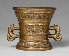 A magnificent small Hachmann mortar made for Heinrich Honnen, A magnificent small Hachmann mortar made for Heinrich Honnen, Golden brown cast bronze with polished natural patina, partially chased. The display side decorated with two winged demi-figures supporting a shield with the initials HK, the reverse with a lion's head mascaron flanked by two facing lions rampant. The rim and centre with cymatium mouldings. With a broad band below the rim inscribed in Gothic minuscule: "von godt kommet al", henrich honnen van godt comet all", the base inscribed with the date in majuscule: "ANNO DOMINI 1597". H 12.8, D