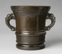 Werkstatt Löffler, A Löffler mortar with dolphin handles, Cast bronze with shimmering chocolate brown patina. Cylindrical form with waisted base and broad flaring stepped rim. With bands of moulding around the centre, the pierced handles formed as finely chased dolphins. H 21, D