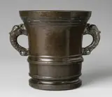 Werkstatt Löffler, A Löffler mortar with dolphin handles, Cast bronze with shimmering chocolate brown patina. Cylindrical form with waisted base and broad flaring stepped rim. With bands of moulding around the centre, the pierced handles formed as finely chased dolphins. H 21, D