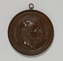 Bernhard Afinger, A cast iron plaque with a portrait of Alexander von Humboldt, Round, bronze patinated plaque in a moulded surround. The lower section chased "B. AFINGER 1854", the reverse engraved "Eigenthum Lauchhammer". D