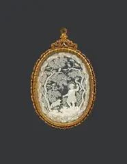 South German 1692, A South German pendant with John the Baptist, 1692, Cut paper between two panes of glass in a gilt bronze surround. With a delicate cut paper depiction of the young John the Baptist in a wooded landscape gesturing towards the Lamb of God, inscribed: "ISTE PVER MAGNVS / CORAM DOMINO / NAM ET / MANVS EIVS / CVM IPSO / EST / 1692." The paper slightly yellowed, otherwise in pristine condition