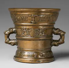 A dated Hachmann mortar, A dated Hachmann mortar, Cast bronze with slightly mottled golden brown natural patina. Decorated with a heraldic shield bearing the house mark supported by two winged half-figures. To the reverse a medallion with the Veil of Veronica flanked by two putti. The broad rim inscribed in Gothic minuscule "jacob die greif cily syn huisfrouw" with a dog, a rabbit, and a winged caryatid. The base inscribed "int jaer ons heren mvclxxvi". H 17.1, D