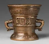 A dated Hachmann mortar with romantic inscription, A dated Hachmann mortar with romantic inscription, Cast bronze with honey coloured natural patina. Decorated with a pair of winged half-figures supporting a vacant shield avers, and a depiction of the Veil of Veronica flanked by two putti to the reverse. Inscribed in Gothic minuscule below the rim "wilhelm hoch lybet syn huisfrouw", and around the base "ANNO DOMINI MVCLXXVII". H 14.3, D