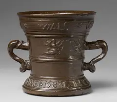 A dated Hachmann mortar with dolphin handles, A dated Hachmann mortar with dolphin handles, Cast bronze, the chocolate brown patina presumably varnished. Decorated with a vacant heraldic shield supported by two winged half-figures. A broad banderole surrounding the rim inscribed "ALTyT NV WALS GODT". The base inscribed "IN DEO SPES MEA ANNO 1583". H 14.4, D