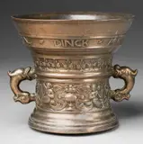 Wegewart foundry, A Netherlandish mortar with a romantic inscription, Cast bronze with golden brown natural patina. With two bands of ornament: Winged figures and vases below and flowerheads above. A banderole around the rim inscribed and dated "LIEFTE VERWINDT AL DINCK AO 1598". H 13.1, D