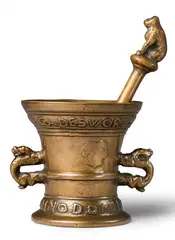 A dated Hachmann mortar with a bear pestle, A dated Hachmann mortar with a bear pestle, Cast bronze with golden brown patina. A broad banderole around the rim inscribed "GADES WORT SAL BLIVEN IN EVICHKEIT", the base dated "ANNO DOMINI 1589". Decorated with a worn vacant (?) shield. The handles formed as crouching dragons. The pestle presumably original, with a central pommel and finial formed as a bear. H 13.5, D