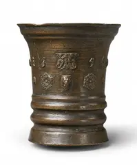 Werkstatt Grassmayr, A dated Grassmayr mortar with a lion's head, Golden brown cast bronze with slightly mottled brown patina. Cast with a series of motifs to the centre: A stylised rose, mascarons, a lion's head, and grotesque figures surrounding the date "1656". With one angular facetted handle. H 16, D