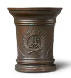 Werkstatt Grassmayr, A dated Grassmayr mortar, Golden brown cast bronze with reddish brown patina. Cast with the initials "IP" and date "1709" in a crowned oval medallion flanked by palm fronds. The sides with large sage leaves. One dolphin handle. H 19.5, D