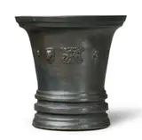 Werkstatt Grassmayr, An early Grassmayr mortar with lion mascarons, Cast bronze with brown lustrous patina. The front cast with a row of putto's heads, two lion mascarons and two grotesques. With an angular facetted handle. H 17, D
