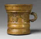 Werkstatt Grassmayr, A dated Grassmayr mortar with grasshoppers and a coin medallion, Cast bronze with slightly mottled pale brown patina. Cast with a series of motifs around the centre of the vessel: Grasshoppers, leaves, vases of flowers, mascarons, and a coin medallion dated "1693". With an engraved owner's cypher beside the dolphin handle. H 15, D