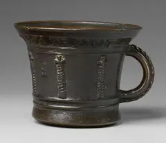 Foundry Crescimbeni, A rare Italian ribbed mortar, Cast bronze with dark brown patina. Squat, slightly tapering form with flared rim. Cast with six twisted columns beneath Gothic capitals and the initials "S E". The caster's signature inscribed around the rim "CRESCENBENI ME FECIT". C-shaped handles with braided appliques. H 12.8, D