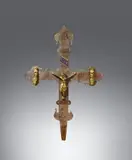 West Germany 14th century, A 14th century West German processional cross, Brass cross with engraved and enamelled decor. Cast bronze figures with chased details. Remains of gilding. The beams of the cross with foliate terminals and decorated with stylised engraved tendrils to the avers, except in the areas surrounding the mourning Virgin and Saint John. The reverse engraved with depictions of Christ Enthroned, the four symbols of the Evangelists, and tendrils on embossed ground. Drilled holes to the cross, the figures loosely attached. Four enamel plaques and two figures lost. Wear and dents with minor losses