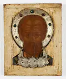 Ikone mit der Darstellung des hl. Nikolaus by Russischer Meister wohl 17. Jahrhundert, Tempera auf Holz, freigelegter Weißgrund, Metallnimbus und Tsata, farbige Glassteine, sold Sep 2018