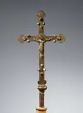 A 13th century processional cross, presumably French by Probably France 13th century, Embossed and engraved bronze and brass, with remains of gilding, set with coloured stones. The bronze Corpus Christi is , sold May 2018