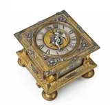 David Weber, An Augsburg single-hand table clock, Engraved and gilt bronze with parcel gilt silver dial and appliques, glass, brass, steel, silver-plated bronze bell to the base. Day-running with hourly striking. Horizontal clock in a cuboid case with glazed openings to the facets, resting on on high turned feet. The mobile hand supported by the figure of an angel applied to the central gilt alarm aperture. With flowerhead caps to the angles and engraved floral decor to the edge of the plate. Engraved to the plate: David Weber Augusta (?). Minimal losses to the appliques