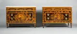 Gaspare Bassani, Two Neoclassical marquetry chests of drawers, Palisander, maple, and rosewood veneer on walnut and oak with fine marquetry in various stained and natural woods. With ormolu mountings (some defective or replaced) and later Carrara marble top. A rare pair of chests with finely ornamented fronts. Of angular form with three drawers on tapered square-section legs, the angles ornamented by columns. The upper drawer decorated with floral swags, the two lower drawers with round medallions depicting ruins in landscapes and a broad foliate border. Some older repairs, minor losses, the colours to one front changed. H 89 and 89.5, W 123, D