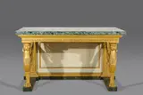 Leopoldo Pollack, An Italian Empire wall bracket, Carved and gilt softwood, painted in colours and white, marble top. An important and monumental wall bracket with carved decor depicting two winged lions supporting the architrave and marble top. The closed back panel flanked by two pilasters. The base painted to imitate black and green serpentine. Two open shrinkage cracks to the back panel, partially retouched repairs and subsequent cracks. H 106, W 181, D