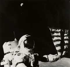 Apollo 17, Astronaut Eugene A. Cernan adjusts the flag planted on the Moon by Nasa, 1973, Gelatin silver print, printed, sold May 2017