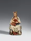 Flemish, circa 1420 & 1430, A Flemish carved wooden figure of the Virgin Enthroned, circa 1420/1430, Carved in the round. With partially overpainted former polychromy. A figure of the crowned Virgin seated on a throne handing an object (possibly a scroll) to the Christ Child, who grasps for the item whilst perching on His Mother’s right knee. The sculpture is characterised by the fine carving of the Madonna’s robes, in which the broad, curving folds of the cloak contrast with the cascade of drapery at Her side. The Child's hands lacking. Minimal losses due to insect damage to plinth and to verso. Minor wear