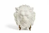 A lion's head mascaron made as decor for Chanel, 1993 by A lion's head mascaron made as decor for Chanel, 1993, Plaster relief on a gilt-bronze metal stand. Chips to edges, the reverse with glued repairs. H, sold Feb 2017