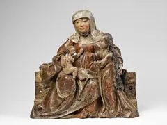 Südtirol ca. 1510, A South Tyrolean carved Swiss pine wood high-relief group of Anna Selbdritt, circa 1510., With older, possibly original, polychromy. St. Anne is shown seated on a broad, block-like bench facing the beholder. She wears a white veil and a simple, floor-length gown. The dark red cloak worn over her left shoulder lies draped across her body and drawn over her knees where it falls in a rich interplay of thick vertical and compressed folds. The Virgin stands next to Her mother, and St. Anne embraces Her with her left arm whilst Mary in turn reaches out towards the Christ Child who is shown seated on His Grandmother’s lap. The drapery of the Virgin’s gown corresponds closely to that of St. Anne’s cloak, lending a harmonic impression to the entire composition. Both the overall design and details of this work, such as the facial features, display direct parallels to another Anna Selbdritt group from South Tyrol (possibly Meran) made in around 1510 - a work closely related to those of the painting and sculpture workshop of Hans Schnatterpeck in Meran and of Matheis Stöberl in Sterzing. Both hands and one arm of the Child missing. Crack in the shoulder of the figure of Saint Anne. Wear to the plint